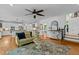 Spacious living room with hardwood floors, a decorative rug, and a view into the kitchen at 106 Birkhaven Dr, Cary, NC 27518