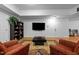 Bright living room with hardwood floors, red armchairs, black coffee table and white walls at 106 Birkhaven Dr, Cary, NC 27518