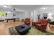 Spacious living room showcases hardwood floors, billiards table, red armchairs and white walls at 106 Birkhaven Dr, Cary, NC 27518