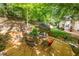 Outdoor dining area on a wooden deck, surrounded by lush greenery, offering a peaceful setting for meals at 106 Birkhaven Dr, Cary, NC 27518