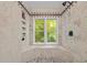 Walk-in shower featuring stone flooring, tiled surround, shampoo niche and an exterior window at 106 Birkhaven Dr, Cary, NC 27518