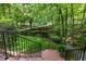 Brick staircase leads to a landscaped yard with mature trees, offering a private and serene outdoor space at 106 Birkhaven Dr, Cary, NC 27518