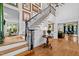 Elegant staircase with wood treads, iron railing and artwork lining the walls at 106 Birkhaven Dr, Cary, NC 27518