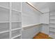 Walk-in closet featuring custom shelving and wood rods provides efficient storage solutions at 106 Birkhaven Dr, Cary, NC 27518
