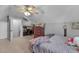 Comfortable bedroom with a sloped ceiling, ceiling fan, dresser, and desk near an open door at 106 Jj Dr, Benson, NC 27504