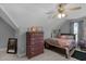 Cozy bedroom with a dresser, ceiling fan, and plush bedding at 106 Jj Dr, Benson, NC 27504