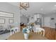 Bright dining area with a round table, elegant chandelier, and views into living room and kitchen at 106 Jj Dr, Benson, NC 27504