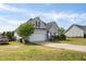 Well-maintained exterior with a two-car garage, lush lawn, and a neatly paved driveway at 106 Jj Dr, Benson, NC 27504