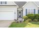 Inviting entrance with a decorative front door, complemented by blue shutters and blooming plants at 106 Jj Dr, Benson, NC 27504