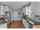 Modern kitchen featuring white cabinets, stainless steel appliances, and granite countertops at 106 Jj Dr, Benson, NC 27504