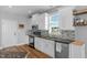 Bright kitchen with white cabinetry, modern appliances, and granite countertops and hardwood floor at 106 Jj Dr, Benson, NC 27504