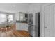 Bright kitchen features granite countertops, stainless steel fridge, and hardwood floors at 106 Jj Dr, Benson, NC 27504