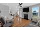 Open-concept living room with a fireplace, hardwood floors, and plenty of natural light at 106 Jj Dr, Benson, NC 27504