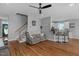 Spacious living room with hardwood floors, complemented by stairs, breakfast bar and modern decor at 106 Jj Dr, Benson, NC 27504