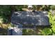 Aerial view of the home showing the roof, stone details, and surrounding mature trees at 109 Edgewood Dr, Louisburg, NC 27549
