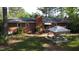 Backyard featuring a well-maintained lawn, patio, and a brick home with awning at 109 Edgewood Dr, Louisburg, NC 27549