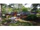 Aerial view of backyard featuring a brick home, patio, and a well-maintained lawn at 109 Edgewood Dr, Louisburg, NC 27549