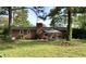 Brick home with backyard featuring a patio area and a well-kept lawn at 109 Edgewood Dr, Louisburg, NC 27549
