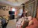 Bedroom featuring a bed, sofa, large TV, and decorative tapestry at 109 Edgewood Dr, Louisburg, NC 27549