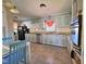 Inviting kitchen with blue cabinets, stainless steel appliances, and a cozy breakfast nook at 109 Edgewood Dr, Louisburg, NC 27549