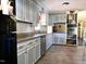 Charming kitchen with painted cabinets, granite countertops, and stainless steel appliances at 109 Edgewood Dr, Louisburg, NC 27549