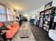 Spacious living room featuring wood floors, a comfortable sofa, and a bookshelf filled with reading material at 109 Edgewood Dr, Louisburg, NC 27549