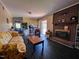 Cozy living room with a brick fireplace, wood-look flooring, and comfortable seating at 109 Edgewood Dr, Louisburg, NC 27549