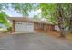 Side exterior featuring a brick facade, a two car garage, and a well-maintained driveway leading up to the home at 1105 Hargrove St, Henderson, NC 27536