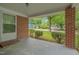 The home's front porch showcasing a brick facade and trimmed doorway offering neighborhood views at 1105 Hargrove St, Henderson, NC 27536