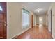 Hallway featuring hardwood floors, access to rooms, and natural light at 1105 Hargrove St, Henderson, NC 27536