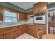 Kitchen with wood cabinets, white countertops, and a built-in oven at 1105 Hargrove St, Henderson, NC 27536
