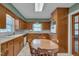 Eat-in kitchen features wood cabinets, a corner sink, and a breakfast area with a round table at 1105 Hargrove St, Henderson, NC 27536