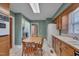 Eat-in kitchen features wood cabinets and a breakfast area with a round table at 1105 Hargrove St, Henderson, NC 27536