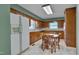 Traditional kitchen with wood cabinets, a dining table, and modern appliances at 1105 Hargrove St, Henderson, NC 27536