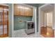 Laundry room with a front-load washer, cabinets above, and access to other rooms at 1105 Hargrove St, Henderson, NC 27536
