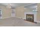 Bright living room featuring a fireplace, a built-in cabinet, and neutral-colored walls at 1105 Hargrove St, Henderson, NC 27536