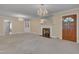 Cozy living room with a fireplace, built-in cabinet, and neutral-toned walls at 1105 Hargrove St, Henderson, NC 27536