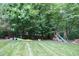 Spacious backyard featuring a wooden playset and a separate ' play area for recreation at 1108 Kalworth Rd, Wake Forest, NC 27587