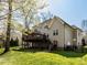 Backyard view showcasing a spacious wooden deck, manicured lawn, and mature trees providing ample shade at 1108 Kalworth Rd, Wake Forest, NC 27587