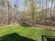Spacious backyard featuring a wooden playset and firepit surrounded by a wooded area at 1108 Kalworth Rd, Wake Forest, NC 27587