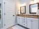 Bright bathroom with dual sinks, framed mirrors, granite countertops, and white cabinets at 1108 Kalworth Rd, Wake Forest, NC 27587