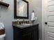Bathroom features a black granite vanity, undermount sink, and framed mirror at 1108 Kalworth Rd, Wake Forest, NC 27587
