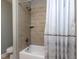 Cozy bathroom with a shower over a tub that features decorative neutral tile at 1108 Kalworth Rd, Wake Forest, NC 27587