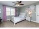 Comfortable bedroom with a ceiling fan, a window and an artistic floral paint feature at 1108 Kalworth Rd, Wake Forest, NC 27587