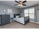 Cozy bedroom with a ceiling fan, neutral walls, and a window with backyard views at 1108 Kalworth Rd, Wake Forest, NC 27587