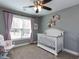 Charming Bedroom with a white crib, rocker, and elegant wall decorations at 1108 Kalworth Rd, Wake Forest, NC 27587