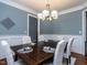 Dining room features a modern chandelier and wainscoting, perfect for Gathering meals at 1108 Kalworth Rd, Wake Forest, NC 27587