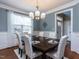 Elegant dining room with a dark wood table, white chairs, and a chandelier at 1108 Kalworth Rd, Wake Forest, NC 27587