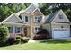 Charming two-story home featuring stone accents, gray siding, a well-manicured lawn and a two car garage at 1108 Kalworth Rd, Wake Forest, NC 27587