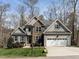 Beautiful two-story home featuring stone accents, a two-car garage, and a well-manicured lawn at 1108 Kalworth Rd, Wake Forest, NC 27587